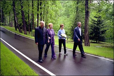 President Bush and Laura Bush walk with President Putin and his wife, Lyudmila, during a visit to the Novo-Ogarevo residence outside Moscow, Russia’s counterpart to America’s Camp David, May 24.