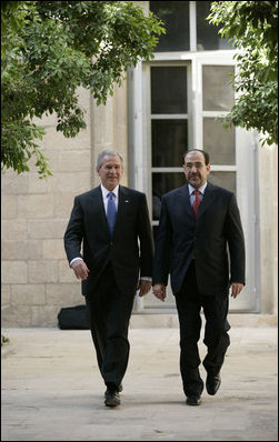 President George W. Bush walks with Prime Minister Nouri al-Maliki Tuesday, June 13, 2006, at the U.S. Embassy in Baghdad, Iraq. During his unannounced trip to Iraq, President Bush thanked the Prime Minister, telling him, "I'm convinced you will succeed, and so will the world." White House photo by Eric Draper 