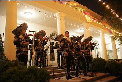 The glow of the White House in celebration of Cinco de Mayo is accompanied by traditional songs in the Rose Garden of the White House Wednesday, May 4, 2005. White House photo by Paul Morse 