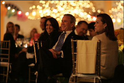 President George W. Bush listens to a mariachi band perform during the White House celebration of Cinco de Mayo in the Rose Garden of the White House Wednesday, May 4, 2005. 
