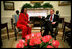 President George W. Bush and Coretta Scott King, the widow of Dr. Martin Luther King, Jr., share a laugh in the Oval Office Jan. 21, 2002. President George W. Bush honored Dr. King in a White House celebration and received a portrait of the civil rights leader from his wife and children in the East Room.