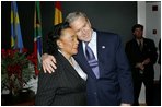 President George W. Bush hugs Coretta Scott King after laying a wreath laying at the grave of Dr. Martin Luther King, Jr. in Atlanta, Georgia, Thursday, Jan. 15, 2004.