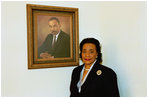 Coretta Scott King poses next to the portrait of her late husband, Dr. Martin Luther King, in the East Colonnade of the White House in Feb. 25, 2004.