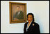 Coretta Scott King poses next to the portrait of her late husband, Dr. Martin Luther King, in the East Colonnade of the White House in Feb. 25, 2004.
