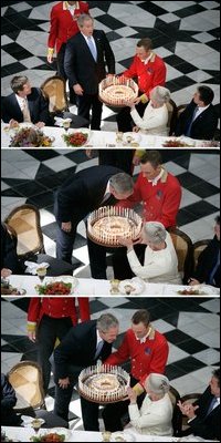 Pictured in this 3-picture combination, President George W. Bush has a little birthday fun with a cake presented to him for his 59th birthday by Her Majesty Queen Margrethe II of Denmark at Fredensborg Palace Wednesday, July 6, 2005.