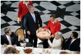 Pictured in this 3-picture combination, President George W. Bush has a little birthday fun with a cake presented to him for his 59th birthday by Her Majesty Queen Margrethe II of Denmark at Fredensborg Palace Wednesday, July 6, 2005.