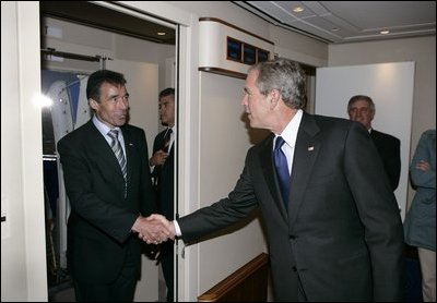 President George W. Bush welcomes Prime Minister Anders Fogh Rasmussen aboard Air Force One after arriving in Kastrup, Denmark, Tuesday, July 5, 2005.
