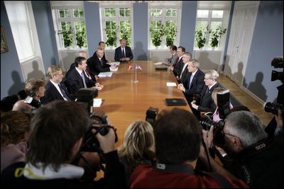 President George W. Bush meets with Danish Prime Minister Anders Fogh Rasmussen, center, left, at his summer residence in Marienborg in Kongens Lyngby, Denmark, Wednesday, July 6, 2005.  "We share the belief that freedom is universal, and we share the belief that in the struggle between democracy and dictatorship, you cannot stay neutral," said Prime Minister Rasmussen. "This is why Denmark contributes with more than 500 troops in Iraq; why we make an active contribution to the joint allied effort in Afghanistan; why we wish to promote democracy and reform in the Middle East; and why we urge all parties to find a peaceful solution to the Arab-Israeli conflict." 