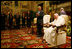 The President and first lady stand and applaud the Pope during their audience with him in June 2004 at which the President presented the Pope with the Medal of Freedom.