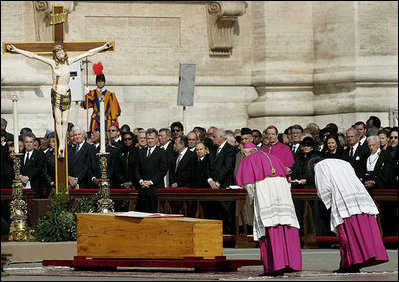 Archbishop Piero Marini, left, master of the liturgical ceremonies, bows to the casket of Pope John Paul II during the Pope's funeral Friday, April 8, 2005, in St. Peter's Square.