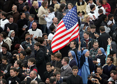 An American flag flies high among the throng of mourners inside St. Peter's square Friday, April 8, 2005, as thousands attend funeral mass for Pope John Paul II, who died April 2 at the age of 84.