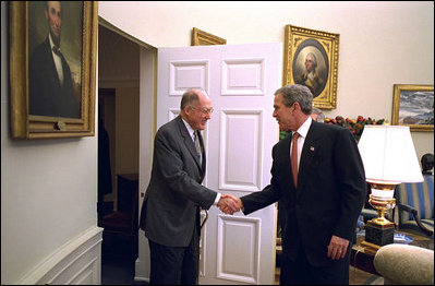 President George W. Bush welcomes Supreme Court Chief Justice William Rehnquist to the Oval Office Dec. 20, 2002. White House photo by Paul Morse