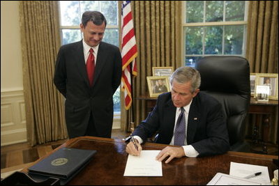 President George W. Bush signs the nomination papers in the Oval Office, Monday morning, Sept. 5, 2005, to nominate U.S. Supreme nominee John Roberts to become Chief Justice. 