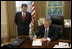 President George W. Bush signs the nomination papers in the Oval Office, Monday morning, Sept. 5, 2005, to nominate U.S. Supreme nominee John Roberts to become Chief Justice. 