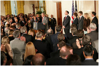 President George W. Bush welcomes an audience to the swearing-in ceremony for U.S. Supreme Court Justice Samuel A. Alito, Tuesday, Feb. 1, 2006 in the East Room of the White House, joined by Altio's wife, Martha-Ann, their son Phil, daughter, Laura, and U.S. Supreme Court Justice John Roberts.