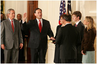 President George W. Bush looks on during the swearing-in ceremony for U.S. Supreme Court Justice Samuel A. Alito, Tuesday, Feb. 1, 2006 in the East Room of the White House, sworn-in by U.S. Supreme Court Chief Justice John Roberts. Alito's wife, Martha-Ann, their son Phil and daughter, Laura, are seen to the right.