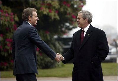 President George W. Bush is greeted by British Prime Minister Tony Blair at Hillsborough Castle near Belfast, Ireland, April 7, 2003.