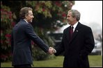 President George W. Bush is greeted by British Prime Minister Tony Blair at Hillsborough Castle near Belfast, Ireland, April 7, 2003.