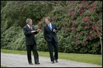 President George W. Bush and British Prime Minister Tony Blair walk through the grounds of Hillsborough Castle in Northern Ireland, Monday, April 7, 2003.