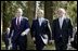 President George W. Bush walks with British Prime Minister Tony Blair, center, and Irish Prime Minister Bertie Ahern at Hillsborough Castle as he prepares to depart Northern Ireland Tuesday, April 8, 2003.