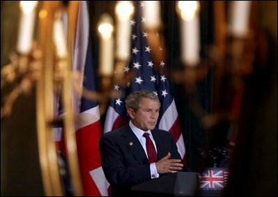 President George W. Bush is reflected in a mirror during a press conference with British Prime Minister Tony Blair at Hillsborough Castle near Belfast, Northern Ireland, Tuesday, April 8, 2003.