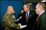 President George W. Bush and Laura Bush attend the U.S. Citizenship Ceremony for Marine Corps Mastery Gunnery Sgt. Guadalupe Denogean of Tucson, Ariz., at the National Naval Medical Center in Bethesda, Md., Friday, April 11, 2003. Pictured at far right, Eduardo Aguirre, Jr., Acting Director of the Bureau of Citizenship and Immigration Services, conducted the ceremony. 