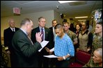 President George W. Bush attends the U.S. Citizenship Ceremony for Marine Corps Lance Cpl. O.J. Santamaria of Daly City, Calif., at the National Naval Medical Center in Bethesda, Md., Friday, April 11, 2003.