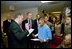 President George W. Bush attends the U.S. Citizenship Ceremony for Marine Corps Lance Cpl. O.J. Santamaria of Daly City, Calif., at the National Naval Medical Center in Bethesda, Md., Friday, April 11, 2003.