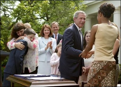 President George W. Bush greets Tamara Brooks after signing the S. 151, PROTECT Act of 2003, in the Rose Garden Wednesday, April 30, 2003. Brooks, 17, was rescued after an AMBER Alert was issued throughout Orange County, Calif., alerting the community of her abduction. Donna Norris, left, embraces her son Ricky after the bill signing. The AMBER Alert system is named in honor of her 9-year-old daughter, Amber Hagerman, who was abducted while playing near her Arlington, Texas, home and later found murdered. 