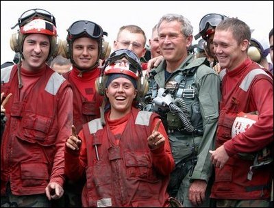 President George W. Bush poses with flight deck crew of the USS Abraham Lincoln May 1, 2003.