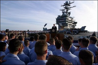 President George W. Bush addresses sailors and the nation from the flight deck of the USS Abraham Lincoln of the coast of San Diego, California May 1, 2003.
