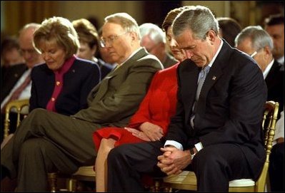 President George W. Bush and Laura Bush bow their heads in prayer during a ceremony marking today as the National Day of Prayer in the East Room Thursday, May 1, 2003. "Today we recognize the many ways our country has been blessed, and we acknowledge the source of those blessings. Millions of Americans seek guidance every day in prayer to the Almighty God. I am one of them," said the President in his remarks.