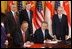 President George W. Bush and Singapore Prime Minister Chok Tong Goh sign a free trade agreement in the East Room Tuesday, May 6, 2003. 