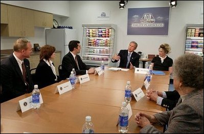President George W. Bush discusses the tax cuts in his economic plan during a roundtable meeting with couples at Airlite Plastics in Omaha, Neb., Monday, May 12, 2003. 
