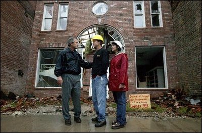 President George W. Bush comforts Scott and Annette Rector in front of their destroyed business in Pierce City, Mo., Tuesday, May 13, 2003. "You can't realize what it's like to see a tornado go right down the main street of a town and just wipe it out," said President Bush as he surveyed the damage from tornados that ripped through southwestern Missouri May 4. "It's hard to envision. But a lot of people know you're suffering, and a lot of people are praying for you, and a lot of people care for you. And a lot of people wish you all the best."
