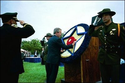 President George W. Bush places a flower on a memorial wreath during the Annual Peace Officers Memorial Service at the U.S. Capitol Washington, D.C., Thursday, May 15, 2003. 