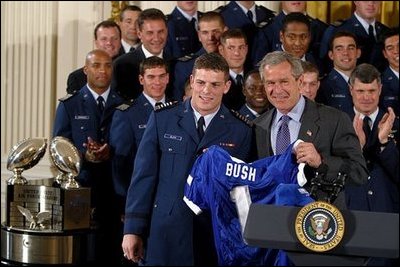 President George W. Bush receives a jersey during the presentation of the Commander-in-Chief's Trophy in the East Room Friday, May 16, 2003. "I'm proud to welcome back to the White House the Air Force Academy Falcons, who have now won the Commander-in-Chief's Trophy for their six consecutive year, and 16th time overall," said the President in his remarks. 