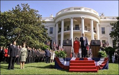 President Bush, President Arroyo, Mrs. Bush and Mr. Arroyo (far left) stand for the playing of the national anthems of the United States and the Philippines at the beginning of the ceremony. 