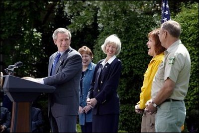 President George W. Bush discusses his plan for wildfire prevention and forest stewardship, the Healthy Forests Initiative, in The East Garden Tuesday, May 20, 2003. Standing on stage with the President are, from left, Agriculture Secretary Veneman, Interior Secretary Gale Norton, Fire Management Officer Andrea Gilham and Wildlife and Fire Staff Officer Rex Mann.