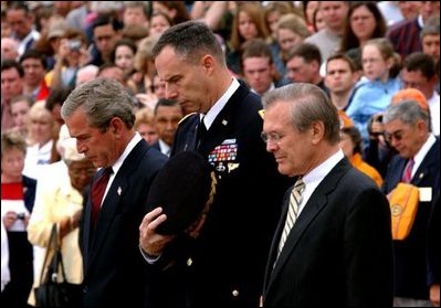 President George W. Bush, Major General James T. Jackson and Secretary of Defense Donald H. Rumsfeld (right) observe a 30-second moment of silence after a wreath-laying ceremony at the Tomb of the Unknown Soldier at Arlington National Cemetery on Memorial Day. Monday, May 26, 2003. 