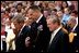 President George W. Bush, Major General James T. Jackson and Secretary of Defense Donald H. Rumsfeld (right) observe a 30-second moment of silence after a wreath-laying ceremony at the Tomb of the Unknown Soldier at Arlington National Cemetery on Memorial Day. Monday, May 26, 2003. 