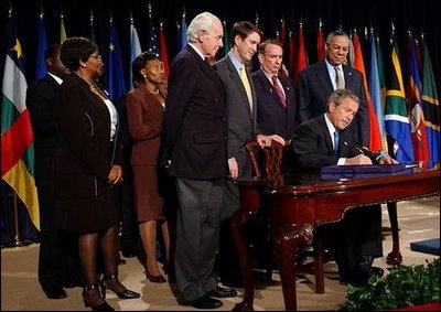 President George W. Bush signs H.R. 1298, the United States Leadership Against HIV/AIDS, Tuberculosis, and Malaria Act of 2003, at the State Department in Washington, D.C., Tuesday, May 27, 2003. The legislation commits $15 billion to fight AIDS abroad. 