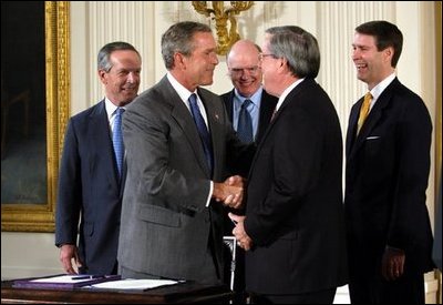 President George W. Bush shakes the hand of Congressman Bill Thomas, R-Calif., after signing the Jobs and Growth Tax Reconciliation Act of 2003 in the East Room Wednesday, May 28, 2003. Also pictured are, from left, Secretary of Commerce Donald Evans, Secretary of the Treasury John Snow and Senate Majority Leader Bill Frist, R-Tenn.