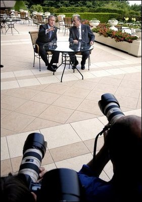 President George W. Bush speaks to the media with French President Jacques Chirac of France at the G8 Summit in Evian, France, Monday, June 2, 2003.