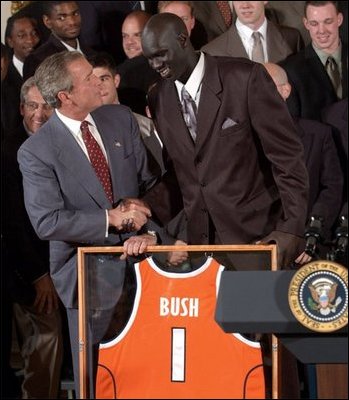 Congratulating the NCAA Winter Championship teams, President George W. Bush stands with Kueth Duany of Syracuse University's mens' basketball team in the East Room Tuesday, June 17, 2003.