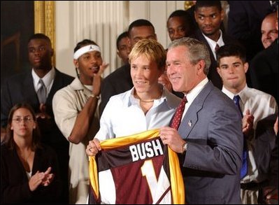 Congratulating the NCAA Winter Championship teams, President George W. Bush stands with Maria Roth of the University of Minnesota-Duluth's women's hockey team in the East Room Tuesday, June 17, 2003.