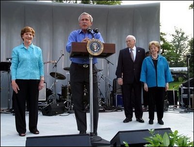 President George W. Bush shares the stage with Laura Bush, Vice President Dick Cheney and Lynne Cheney as he welcomes members of Congress and their families to the Congressional Picnic on the South Lawn Wednesday, June 18, 2003.