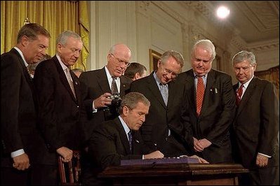 With Senators and members of Congress on hand for the ceremony, President George W. Bush signs the Patriot Act, Anti-Terrorism Legislation, in the East Room Oct. 26, 2001 "With my signature, this law will give intelligence and law enforcement officials important new tools to fight a present danger," said the President in his remarks.