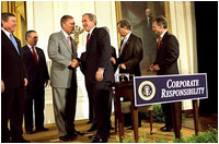 President George W. Bush shakes hands with Congressman Mike Oxley, R-OH, during the signing of the ceremony of the Sarbanes-Oxley Act in the East Room, July 30. 