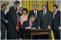 President George W. Bush signs the Trade Act of 2002 in the East Room Tuesday, Aug. 6. "With trade promotion authority, the trade agreements I negotiate will have an up-or-down vote in Congress, giving other countries the confidence to negotiate with us," said the President in his remarks.